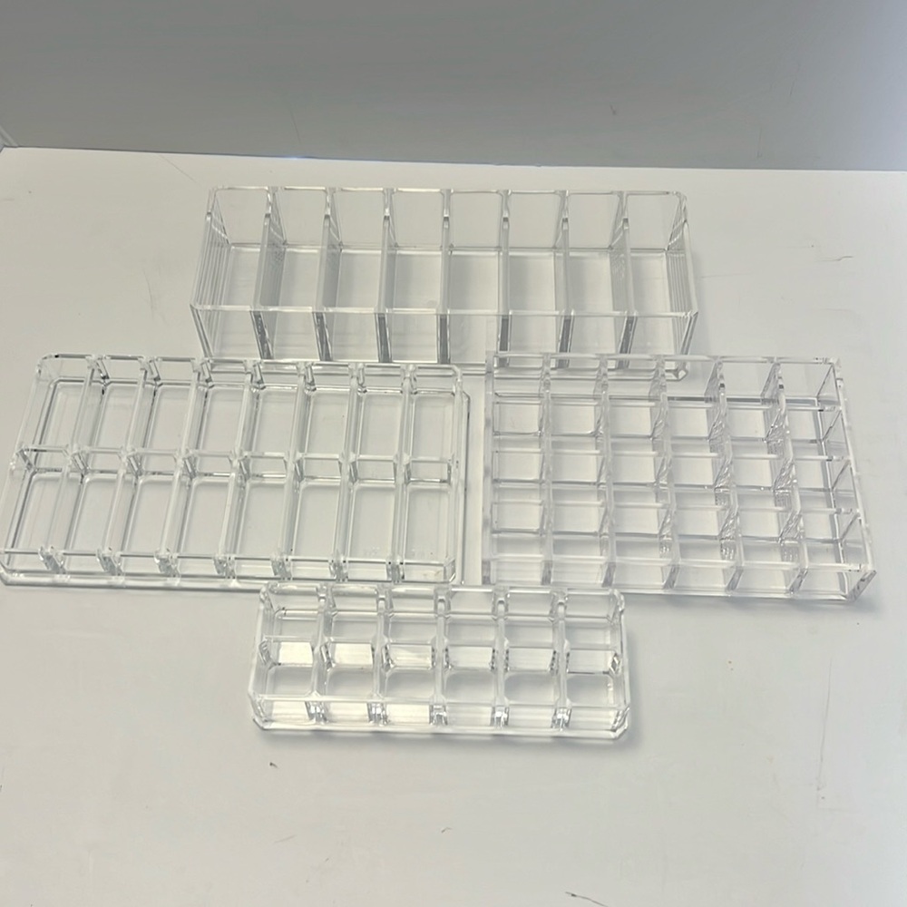4 Lucite makeup organizers. Excellent condition